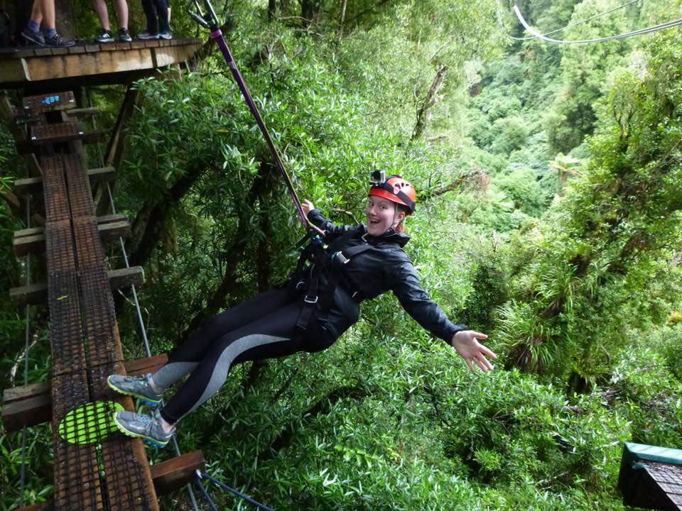 a picture of Stephanie Vance, your travel agent, zip lining in the forest reserves of New Zealand